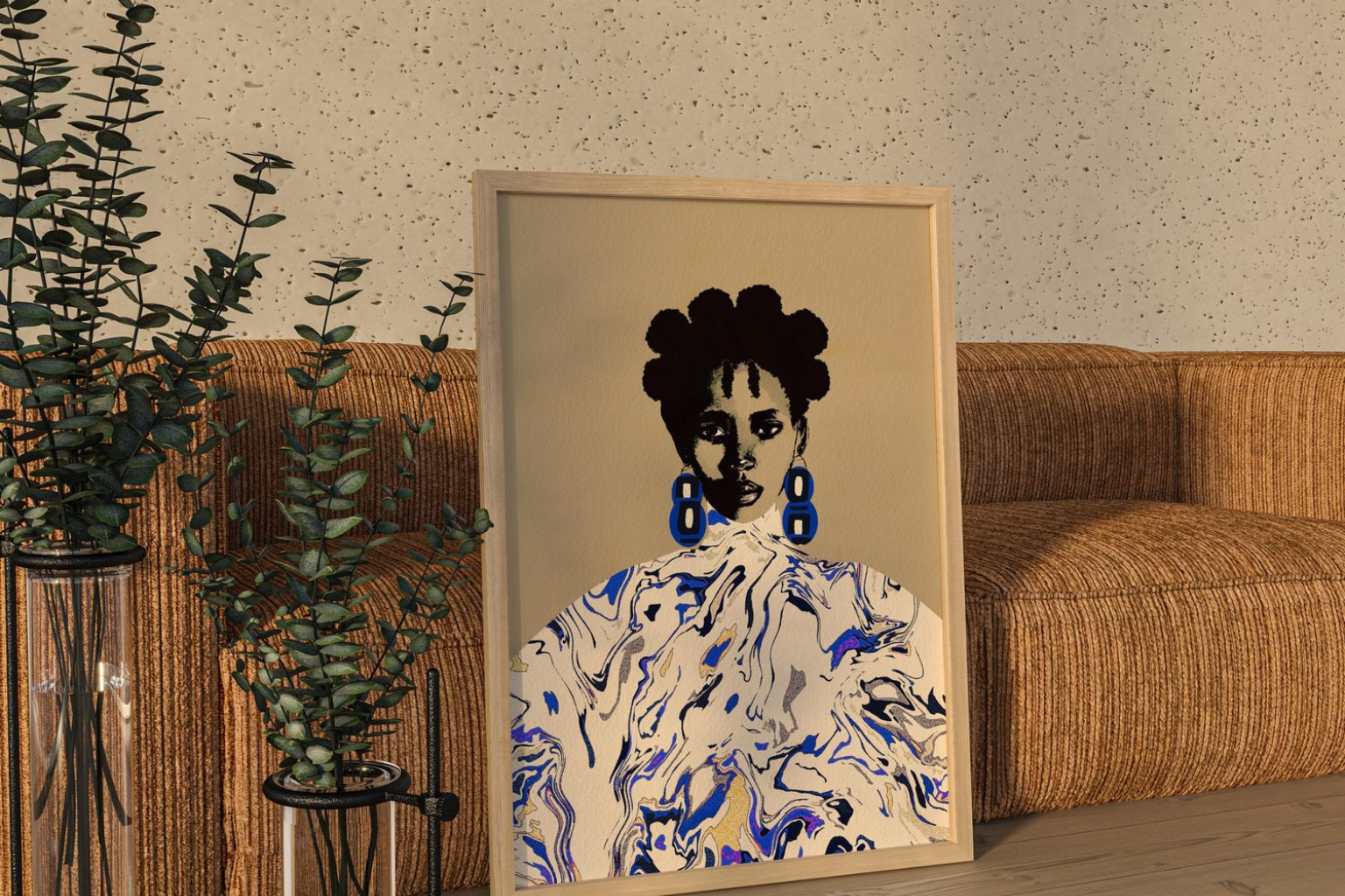 Makara art print by Tamara Tashna, leaned against a brown woven sofa.