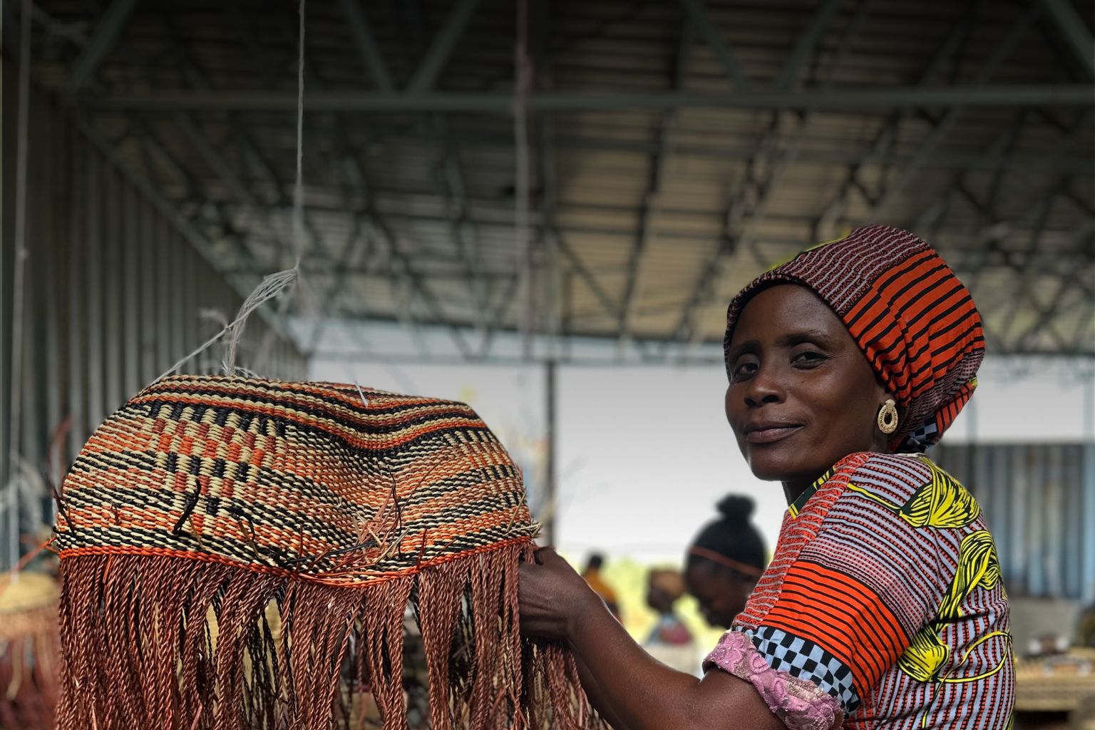 Baba Tree artisan-weaving a basket
