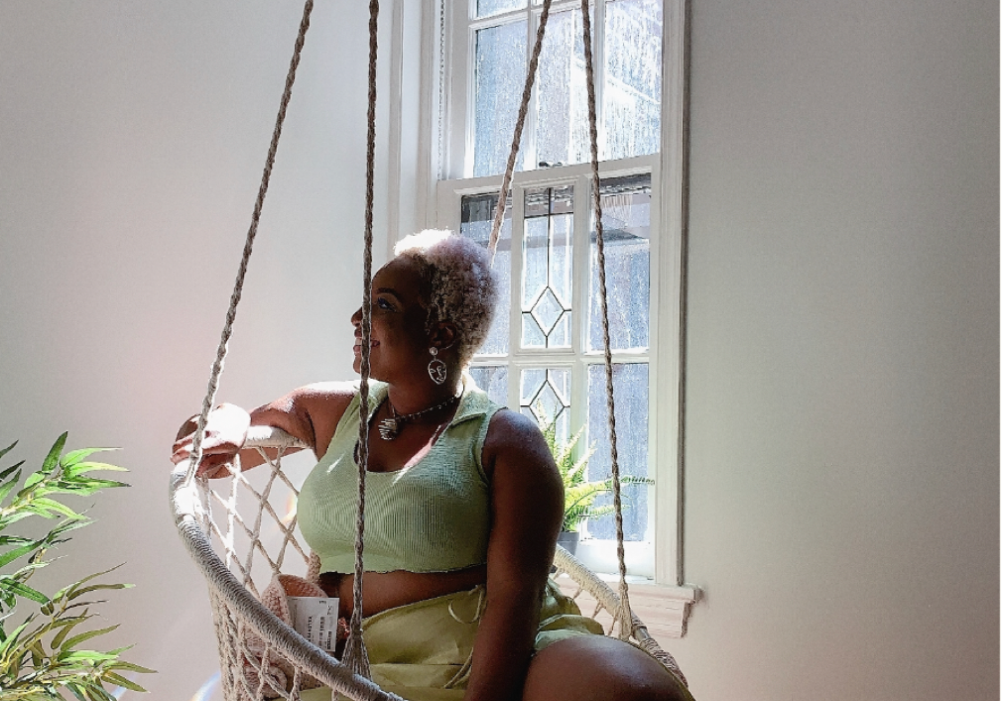 Tamara Tashna sitting in a bright room in green outfit.