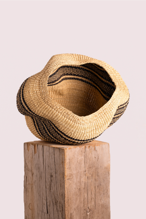 Ebony and natural pebble art basket by Baba Tree, showcasing a handcrafted decorative woven art basket with pebble accents.
