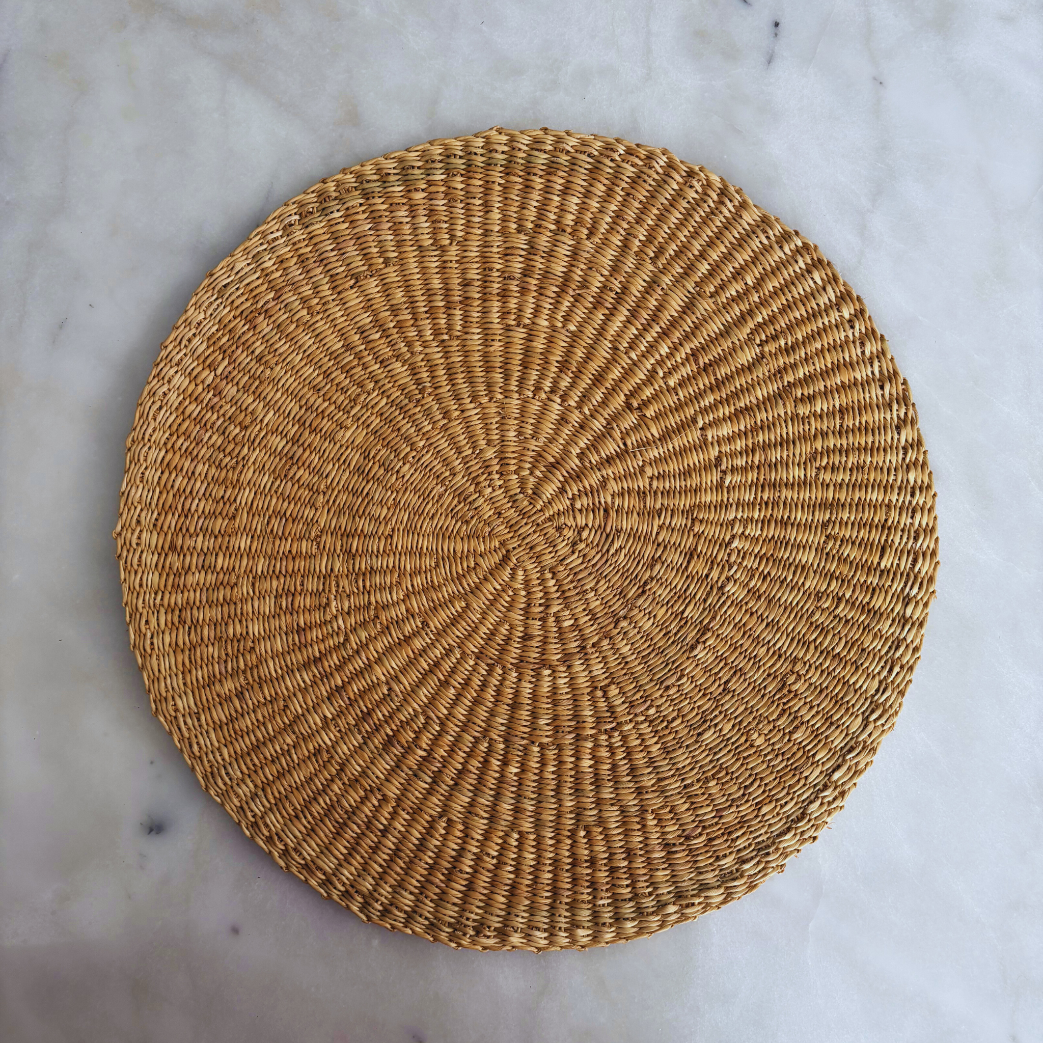Natural Baba Tree placemats in Dune color, made of woven material, showcasing their textured surface and elegant design.