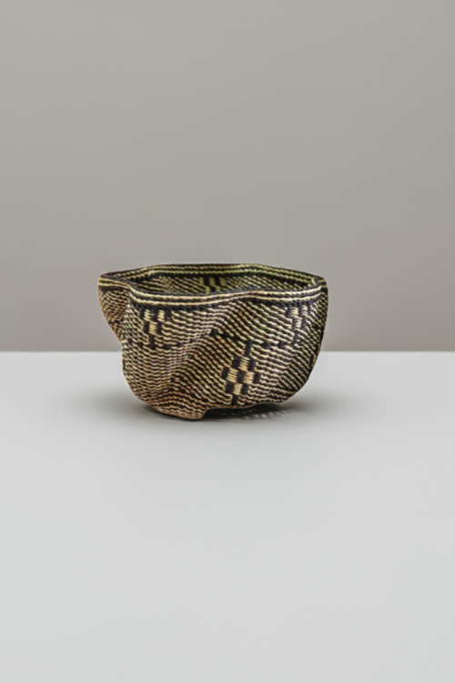 Black and natural Petite Pakurigo Wave Basket by Baba Tree, a stylish woven storage basket with wave design.