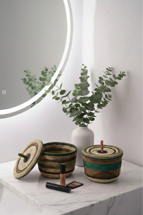 Decorative Baba Tree Banasco woven baskets on a marble surface with a plant and mirror in the background.