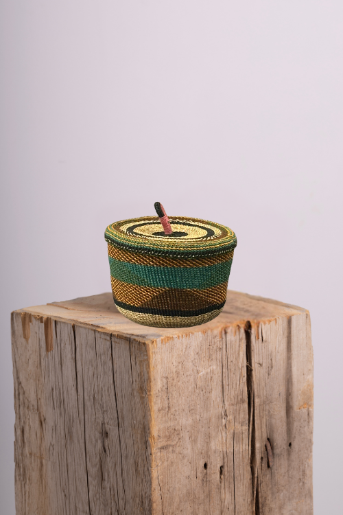 Banasco Basket - Golden Coast with a lid on a wooden block against a light gray background