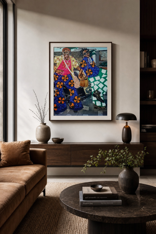 A framed Chisom Chiwete art pring of two young girls in patterned clothing hangs on a light wall above a dark wood console in a styled living room with a brown sofa, round coffee table.