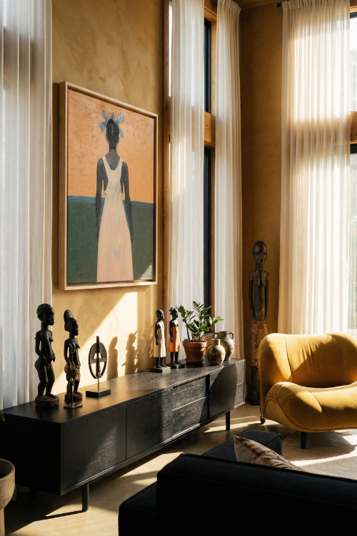 Living room with a yellow armchair, decorative items, and a framed Horizons Dream II Canvas Art artwork on a wall.