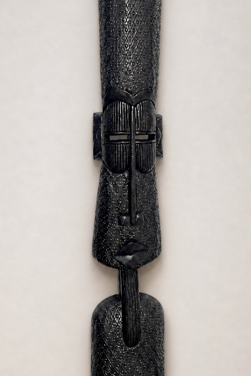 Decorative black wall totem with intricate patterns on a light gray background