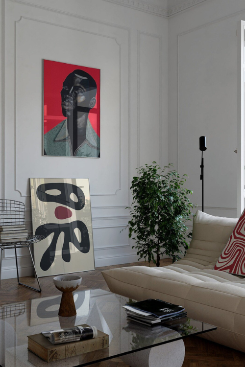 Black art print titled "Remy" by Tamara Tashna, featuring abstract design displayed on a living room wall.
