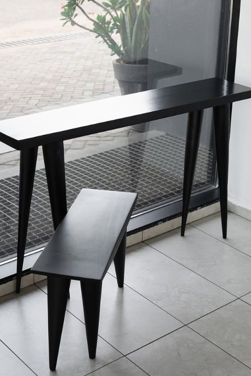 Black Tekura walking console featuring sleek design, modern craftsmanship, and sturdy construction for stylish home decor.