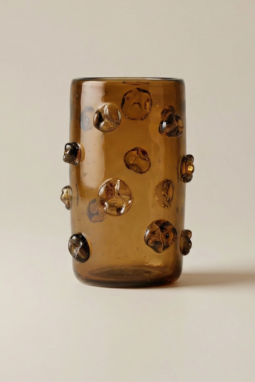 African Nwele Vase Umber by Kitengela Glass, a glass sculpture with warm amber tones and intricate African-inspired design.