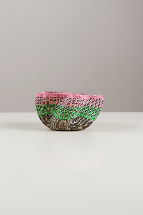 Vibrant Mirage Petite Pakurigo Wave Basket by Baba Tree, a colorful woven storage basket with a wave design and blush accents.