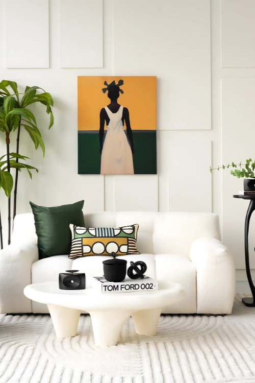 Modern living room with a white sofa, coffee table, and decorative wall art. Featuring baba tree banasco basket and tekura candle holder.