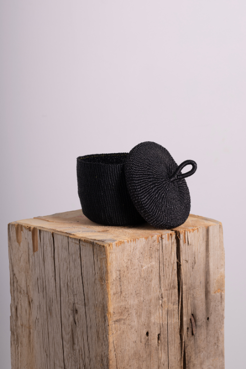 Baba Tree Black banasco basket on a wooden block with a light gray background