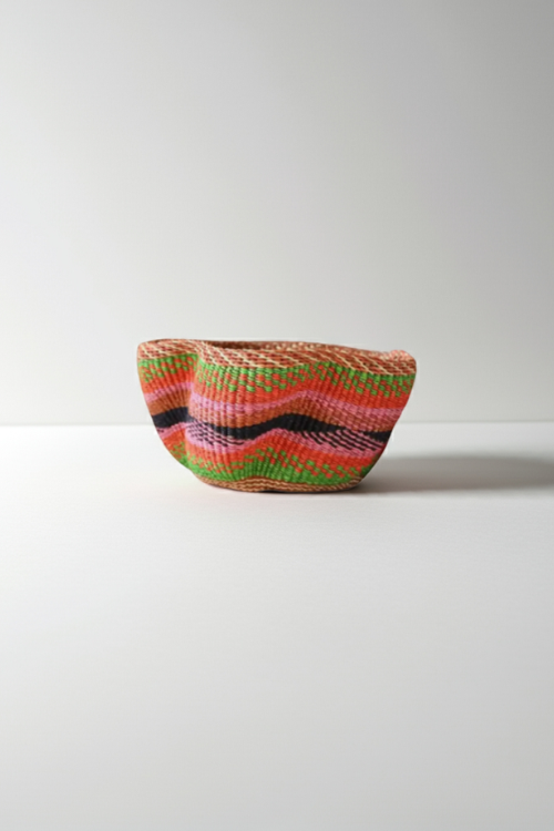 Pink, green, and black woven Petite Pakurigo Wave Basket by Baba Tree, earthy and stylish storage basket with a wave design.