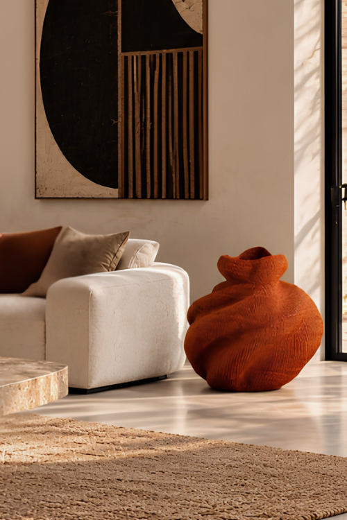 Large sienna coloured woven basket in styled room.