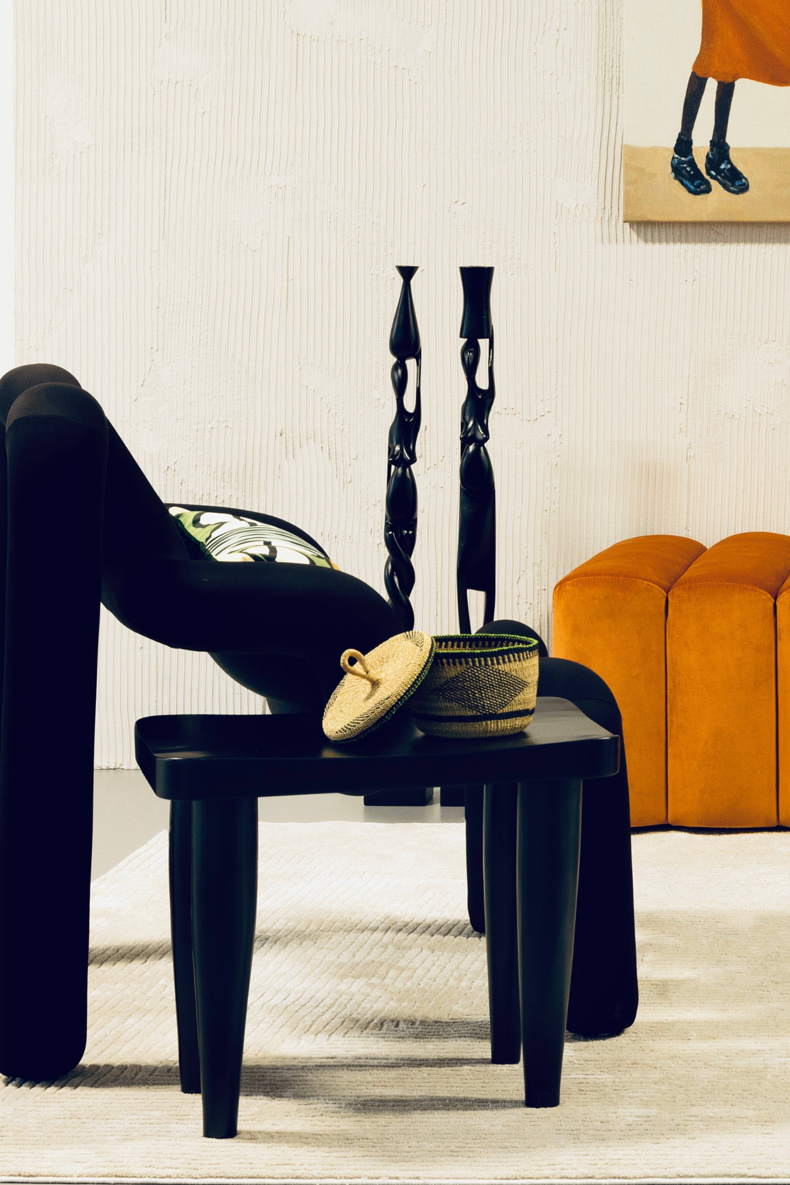 Black Tekura Anantu stool, handcrafted wooden bench from Ghana, showcasing traditional craftsmanship and sleek black finish.