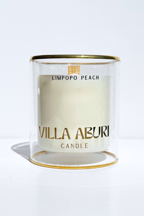 Villa Aburi Limpopo Peach scented candle in 11 oz/325ml glass jar with peach-colored label and decorative wick.