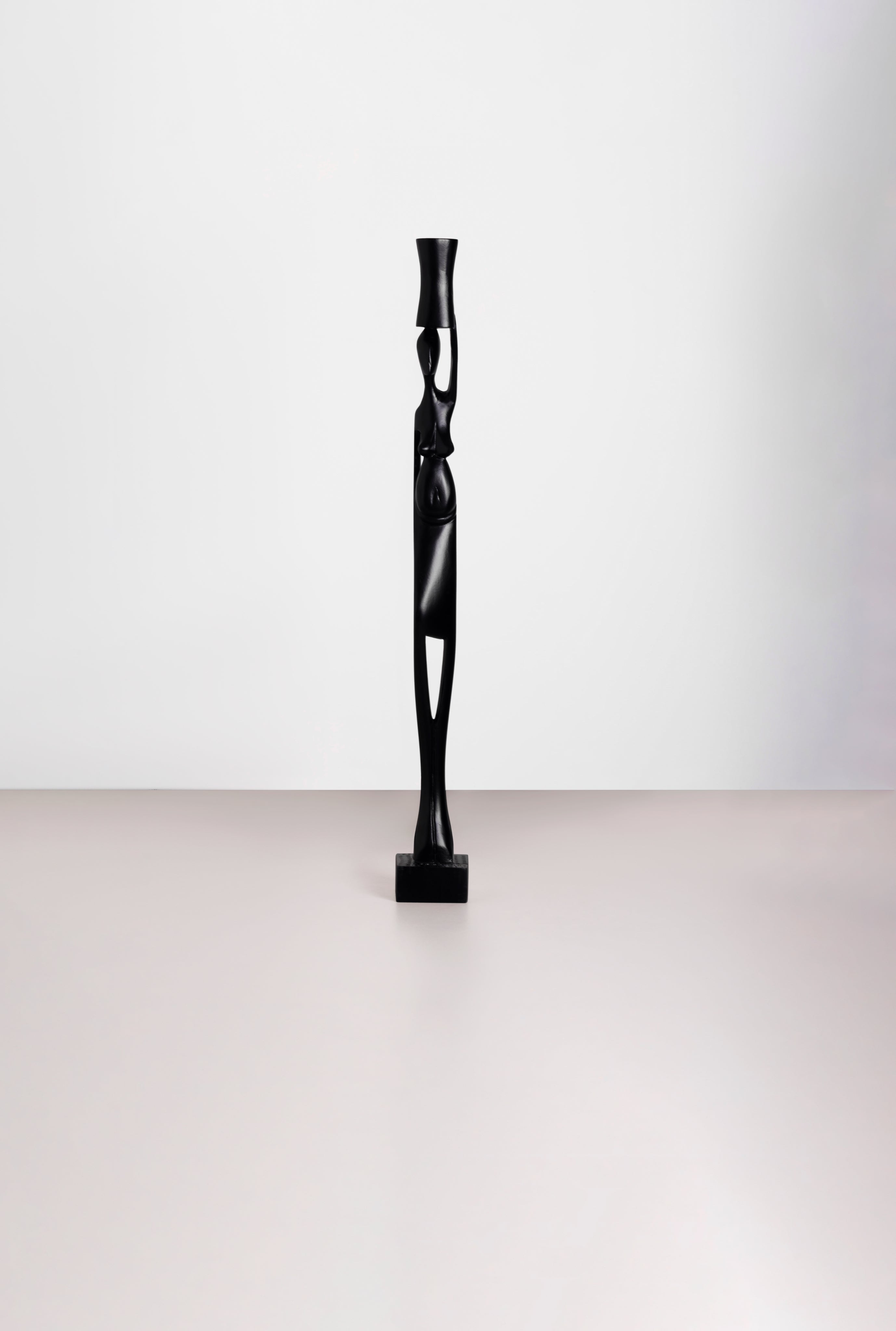 Black Tekura woman carrying pot sculpture, 35-inch tall decorative ceramic sculpture showcasing traditional craftsmanship.