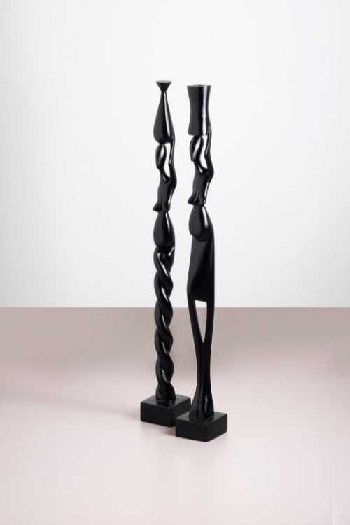 Handcrafted Tekura sculpture of a woman carrying a pot, showcasing detailed craftsmanship and sustainable art design.