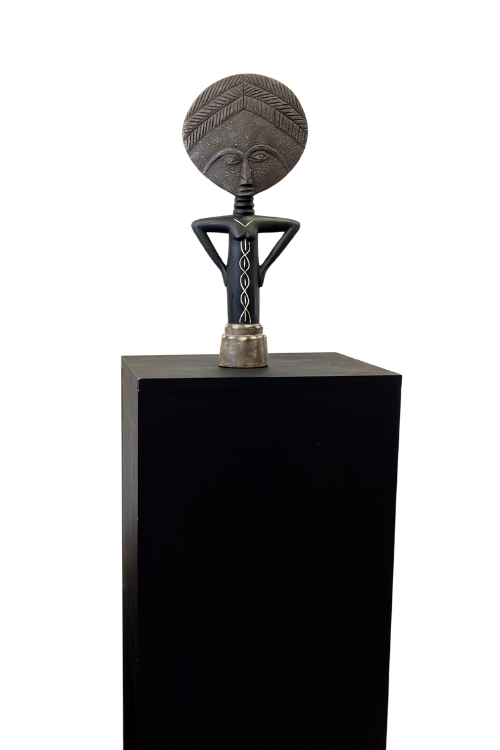 Textured Akuaba Sculpture on a black pedestal