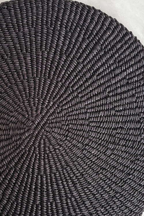 Close-up of a textured black woven placemat c