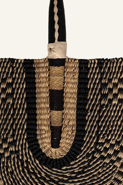 Close up of Handcrafted Bolga Decorative Fan – Black & Natural Essence - Handwoven Elegance from Ghana is a cost-conscious way to bring authentic African craftsmanship into your home.