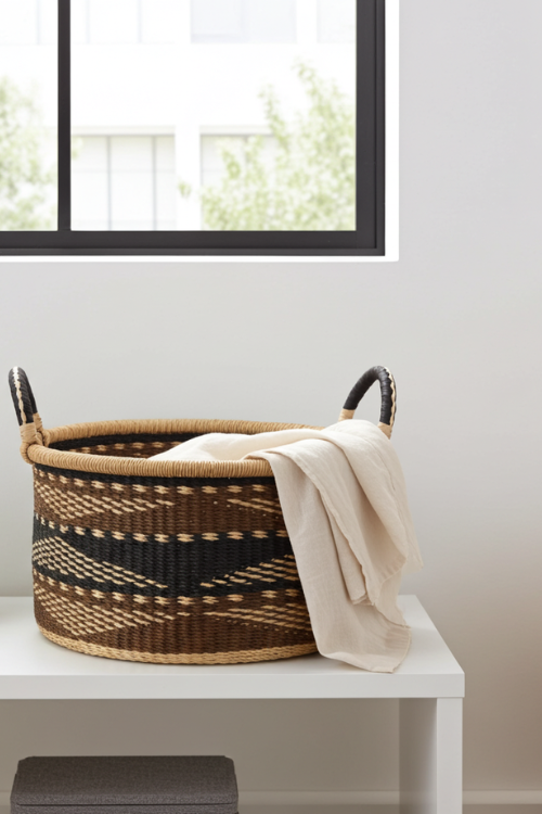 Baba-Tree-Woven-Basket-Half-Tub-Medium-Ancestral-Weave with a towel on a white surface near a window