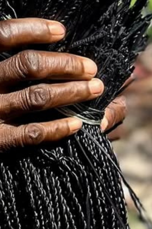 Yoomelingah Yure Artisan Basket - Minimalist Noir - Hand holding a black weaving grass