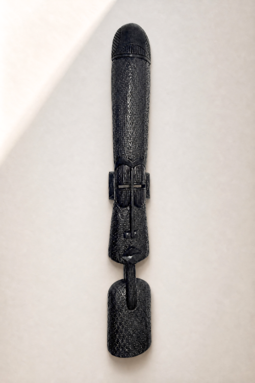 Black textured african wall totem on a light beige background