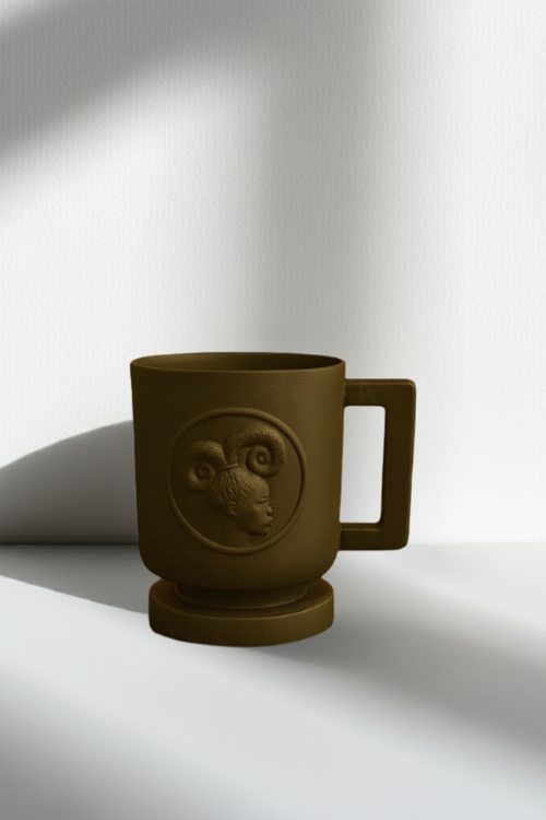 Black mug with embossed design on a white background