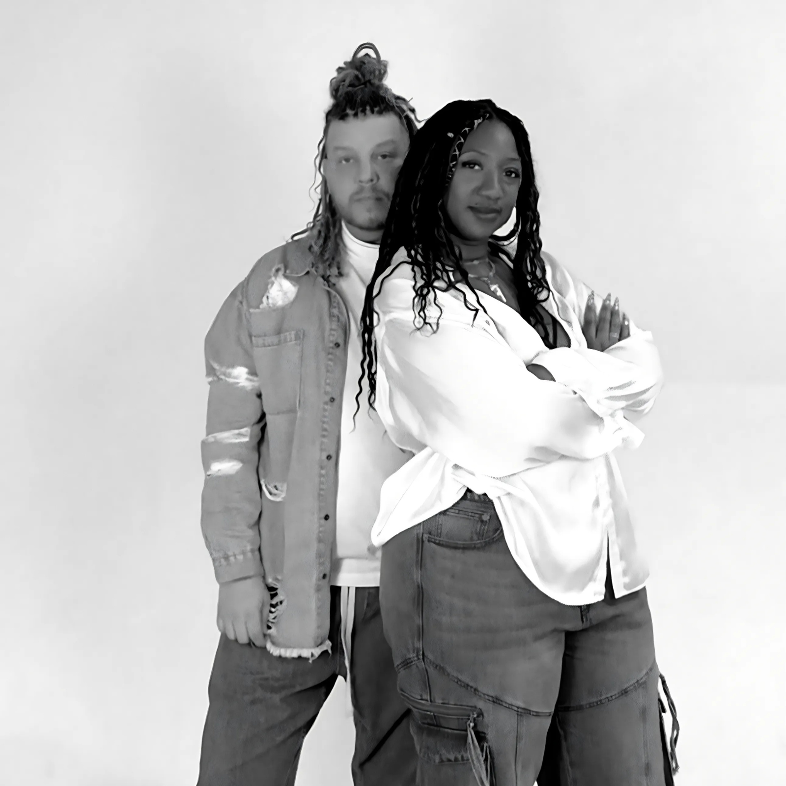 Stacy and Yagger the design team of Villa Aburi standing close together against a plain background