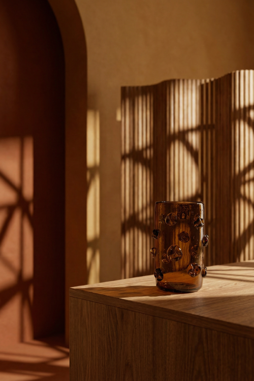 September Collective + Kitengela Glass Nwele Vase in amber glass sculpture with earthy brown tones, showcasing intricate African-inspired design.