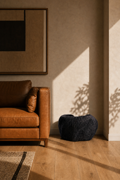 Brown leather sofa in a room with a textured wall and a Pebble Art Basket in black