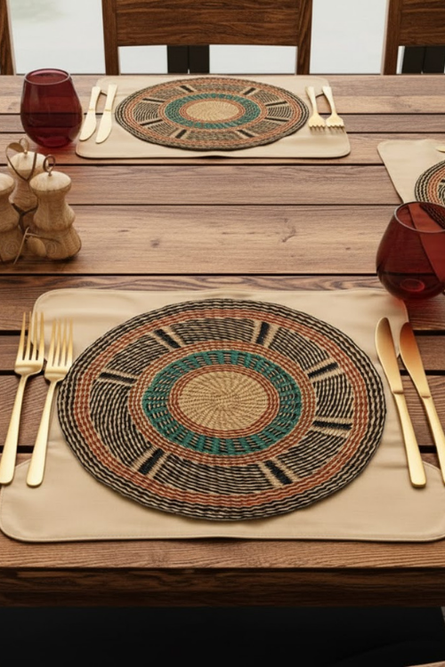 Baba Tree golden coast Woven placemats on a wooden table with cutlery and glasses.