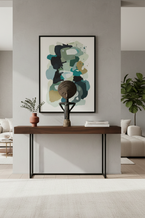 Modern interior with a console table, abstract art, and tekura textured akuaba sculpture.